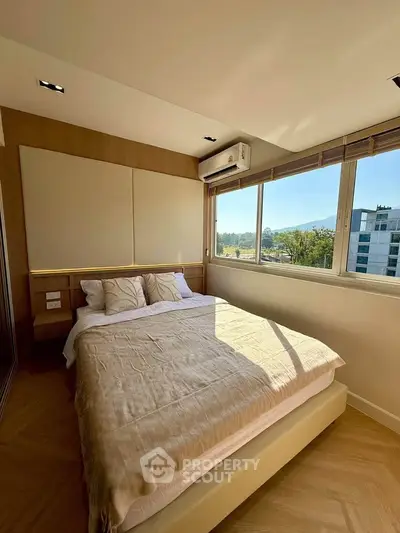 Modern bedroom with large windows and scenic view in a stylish apartment