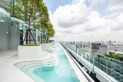 Luxurious rooftop pool with stunning city skyline view, perfect for urban living enthusiasts.