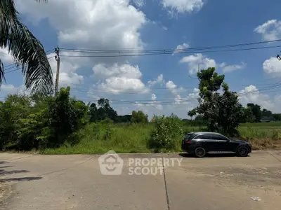 Scenic view of lush green land under a bright blue sky, ideal for development opportunities.