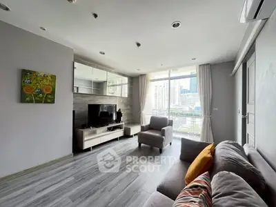 Modern living room with city view, stylish decor, and ample natural light.