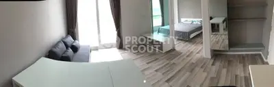 Spacious modern apartment with open layout, featuring a cozy living area and stylish bedroom.