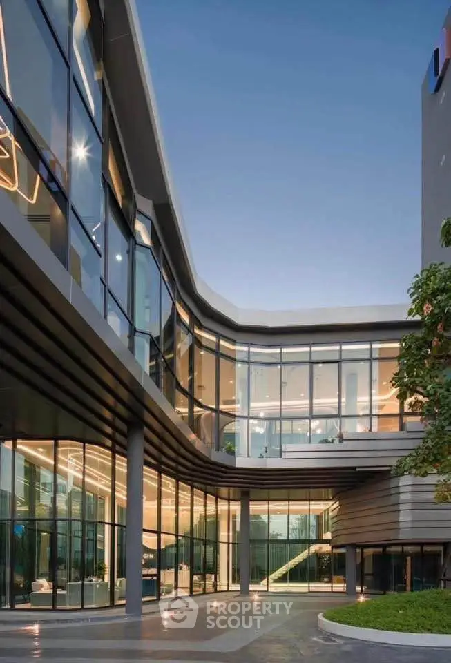 Modern architectural building with glass facade and sleek design, showcasing contemporary urban living.