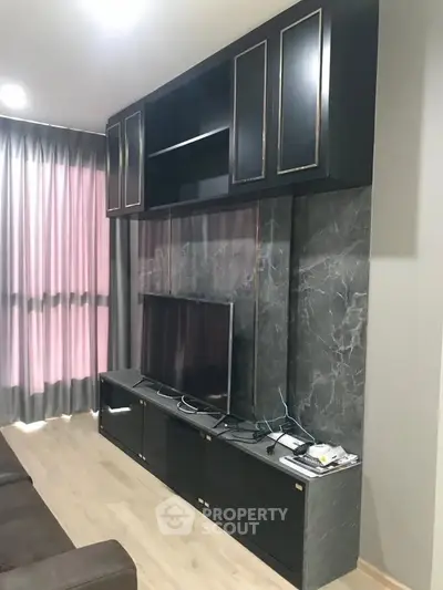 Modern living room with sleek black entertainment unit and marble accent wall