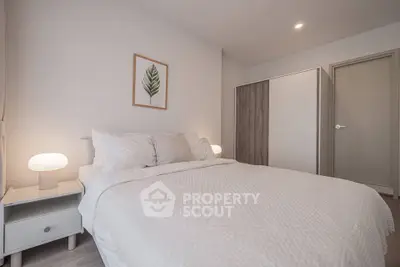 Cozy bedroom with modern decor and soft lighting, featuring a comfortable bed and stylish wardrobe.