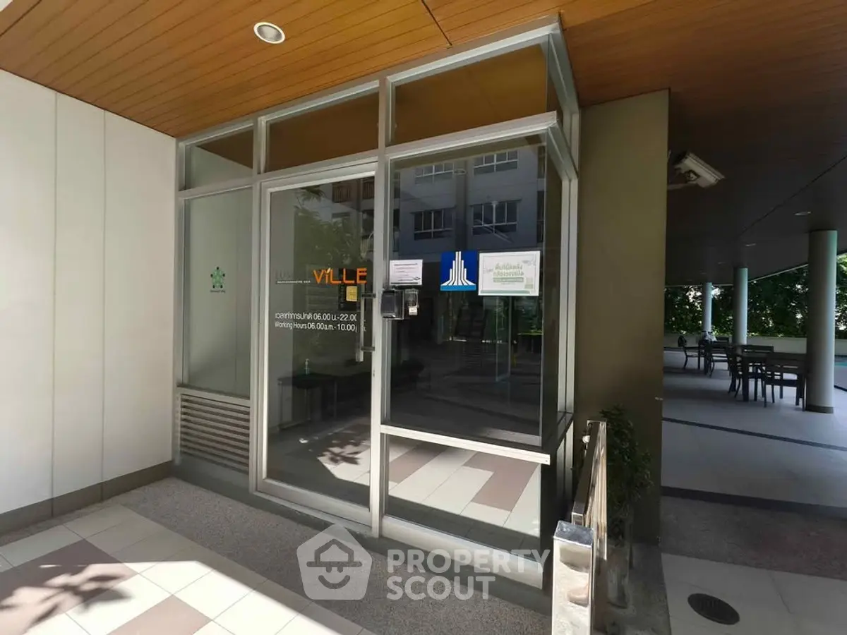 Modern building entrance with glass doors and sleek design, showcasing a welcoming and professional atmosphere.