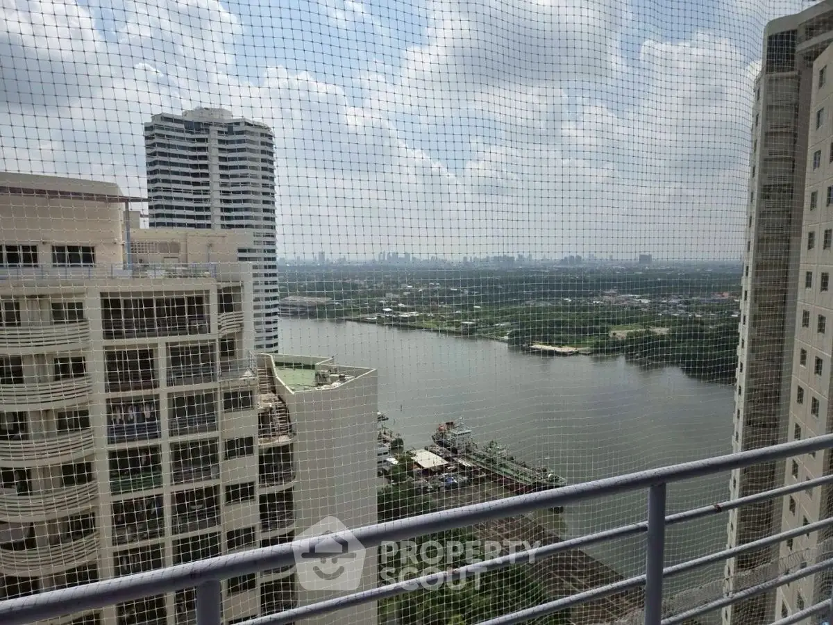Stunning high-rise balcony view overlooking river and city skyline, perfect for urban living.