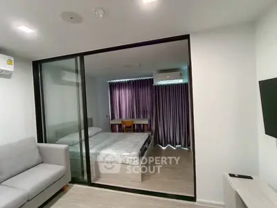 Modern bedroom with glass partition and cozy furnishings