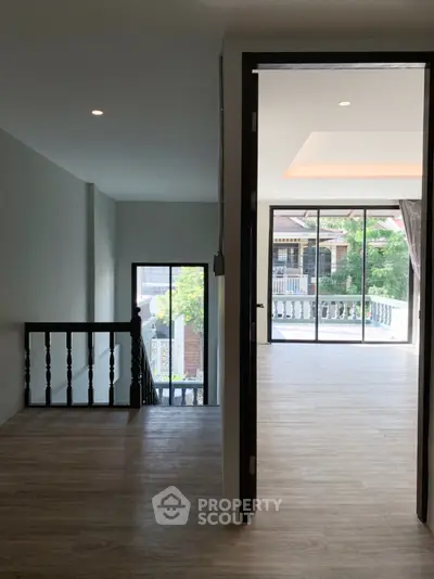 Spacious interior with large windows and balcony access, perfect for natural light lovers.
