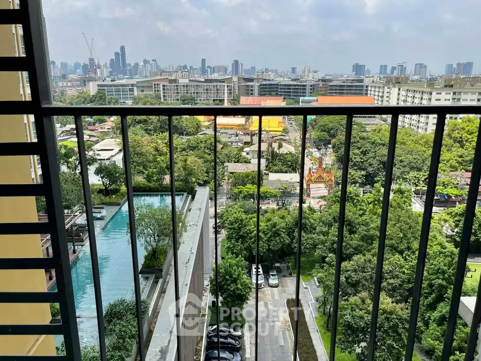 Stunning cityscape view from a high-rise balcony overlooking lush greenery and urban skyline.