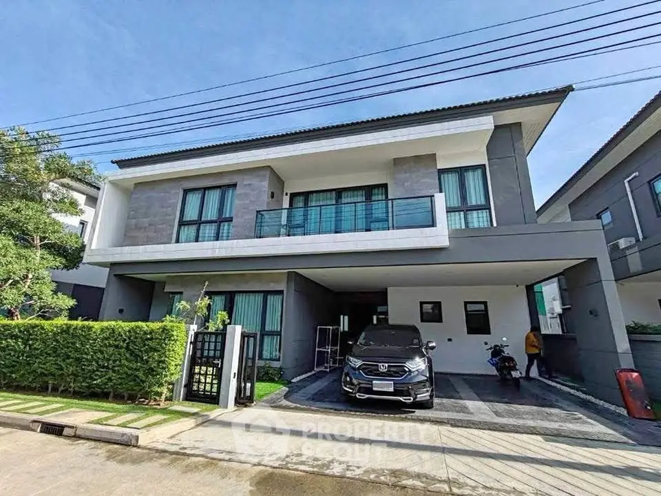 Modern two-story house with sleek design and spacious driveway