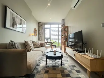 Modern living room with stylish decor and natural light in urban apartment.