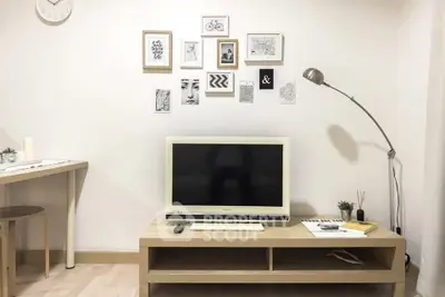Modern living room with stylish decor and flat-screen TV, perfect for cozy relaxation.