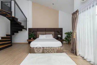 Modern bedroom with stylish staircase and natural light