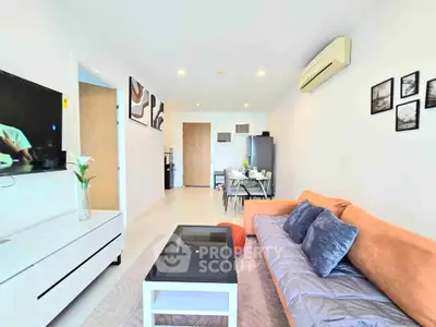 Modern living room with stylish decor, cozy sofa, and wall-mounted TV in a bright apartment.