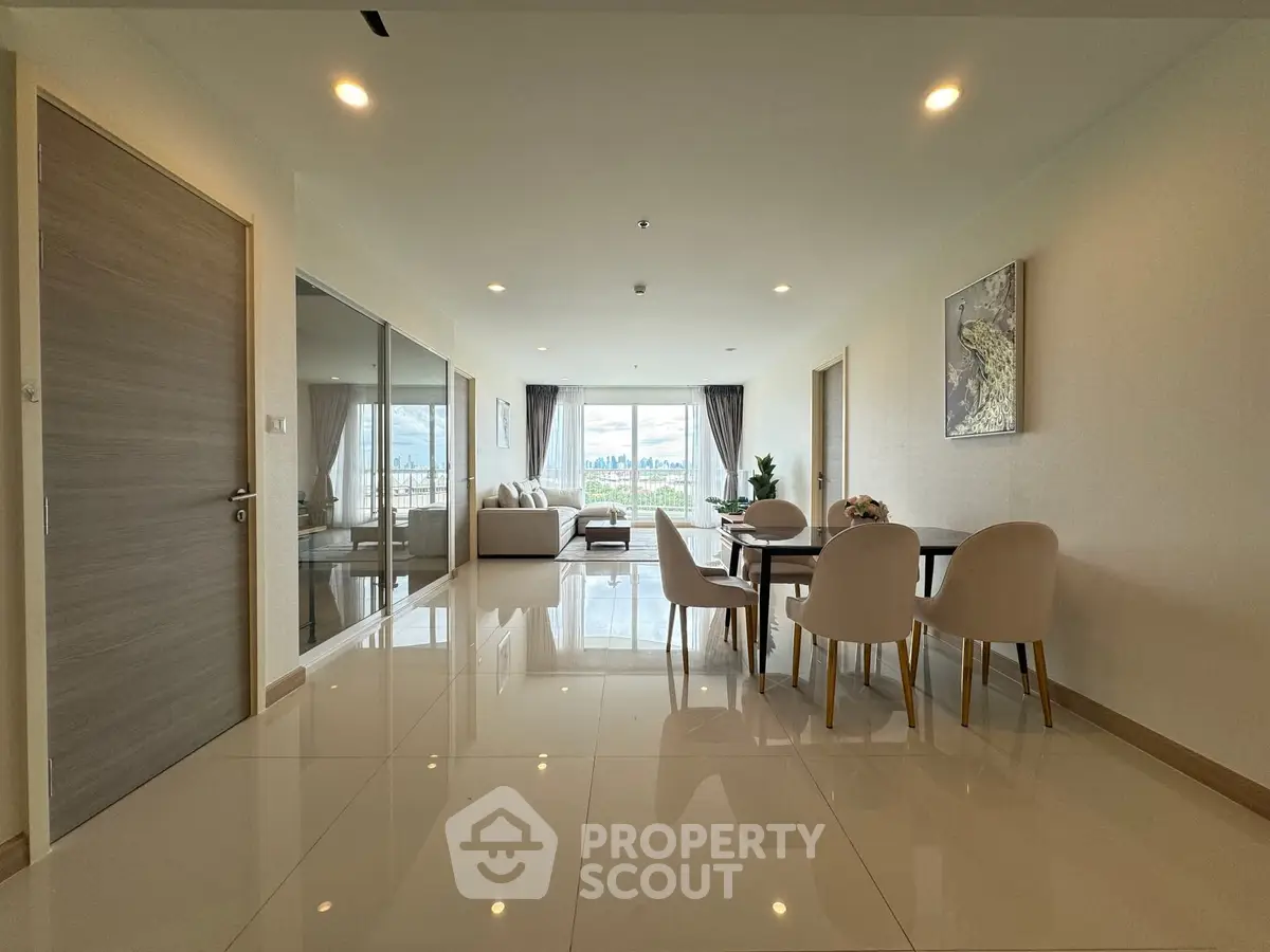 Spacious modern living room with elegant dining area and stunning view.