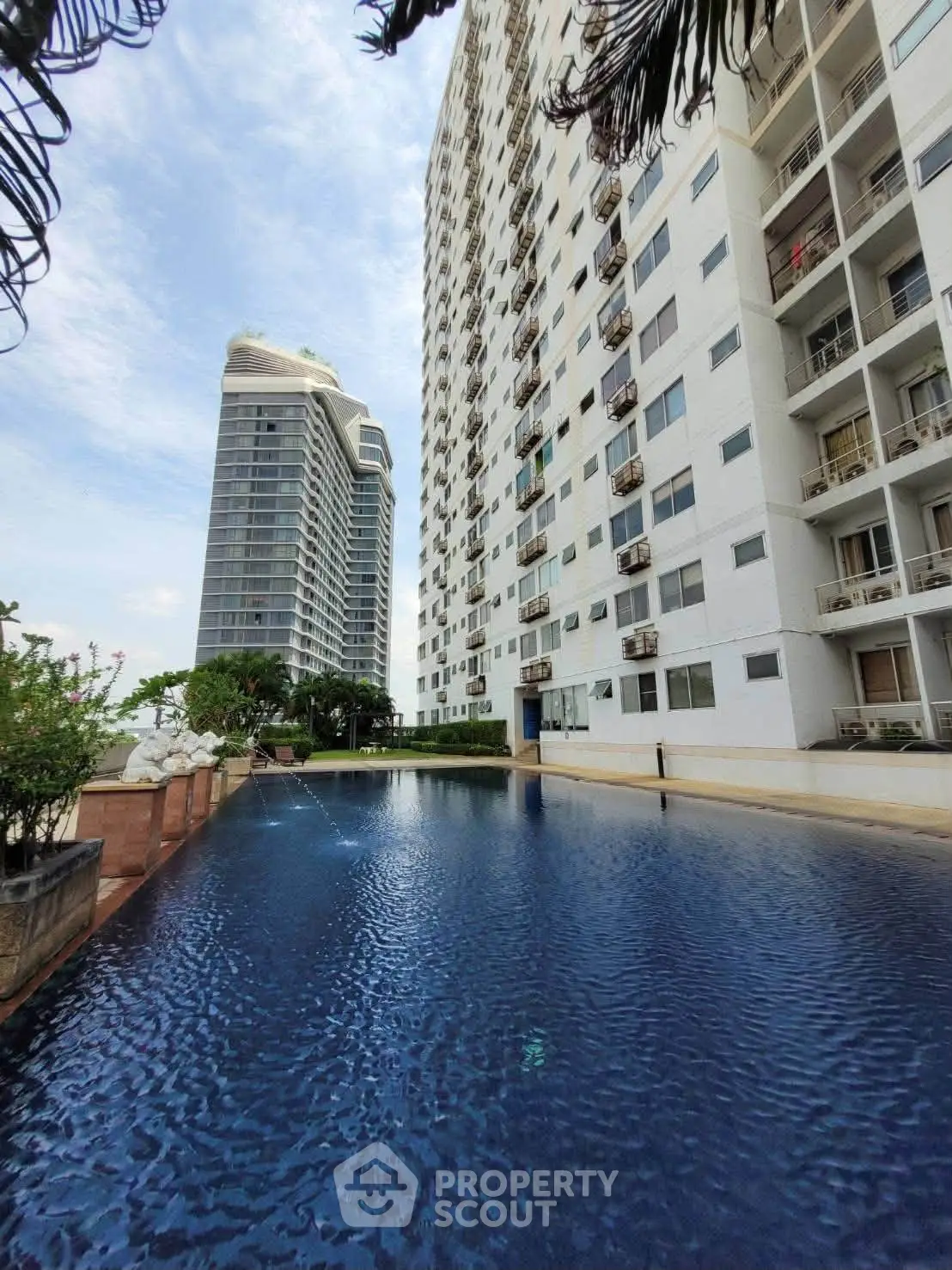 Luxurious high-rise apartment with stunning pool and city view, perfect for urban living.