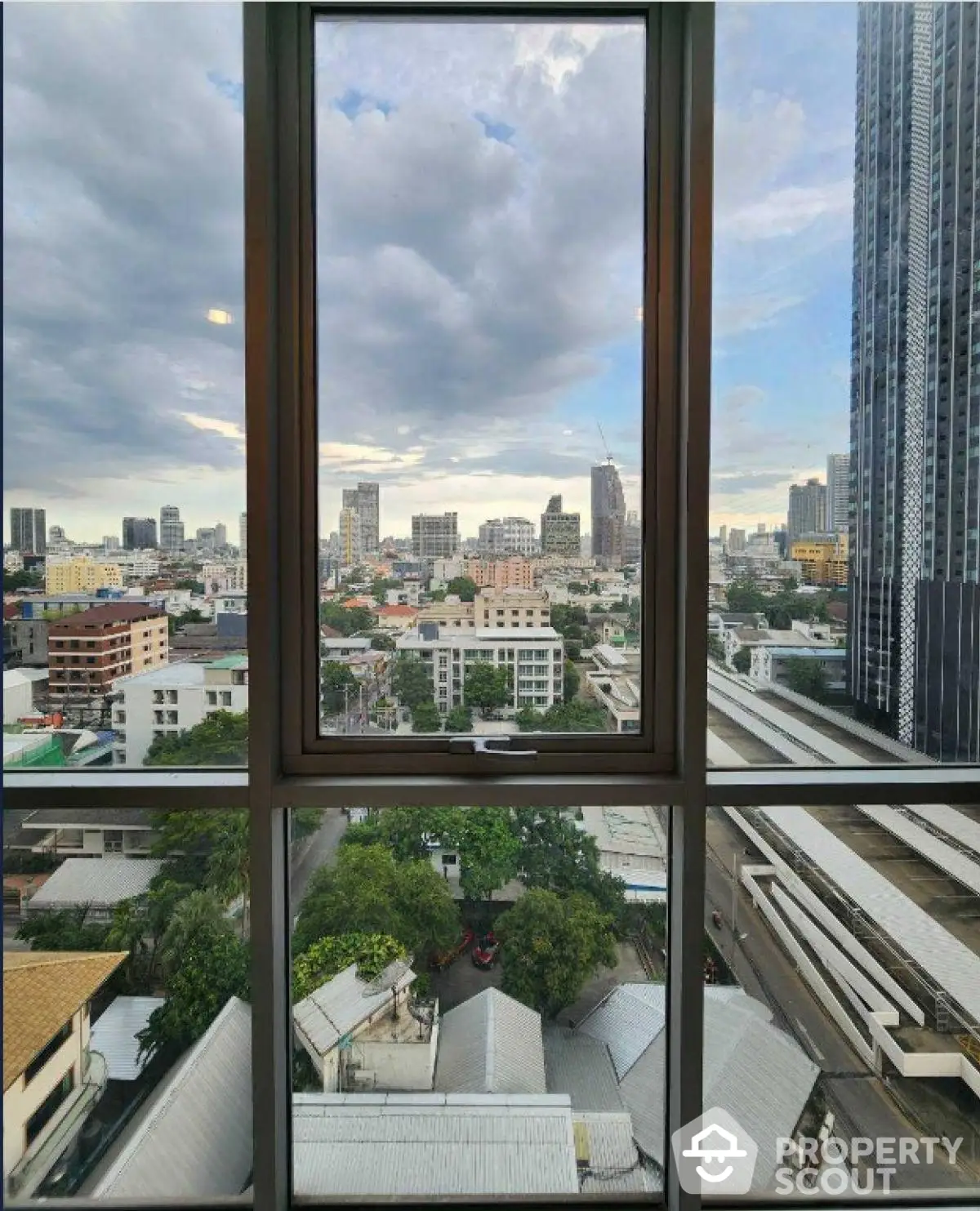 Stunning cityscape view from high-rise window showcasing urban skyline and vibrant city life.