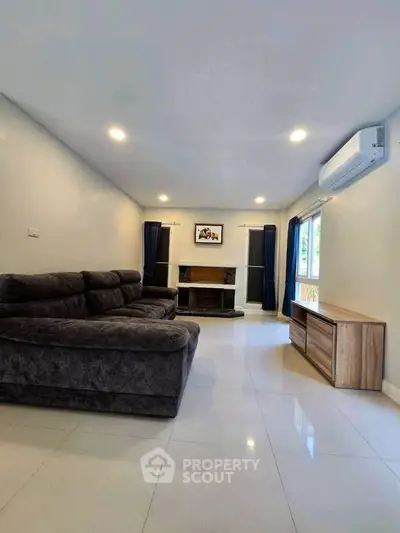 Spacious living room with modern sofa and natural light