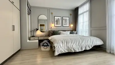 Modern bedroom with stylish decor, large windows, and elegant furnishings.