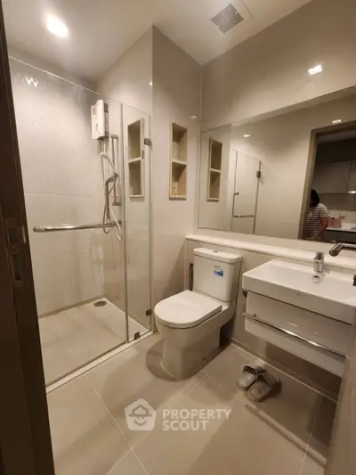 Modern bathroom with glass shower enclosure and sleek fixtures