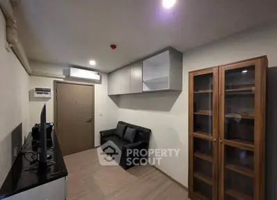 Modern living room with sleek furniture and ample storage in a cozy apartment.