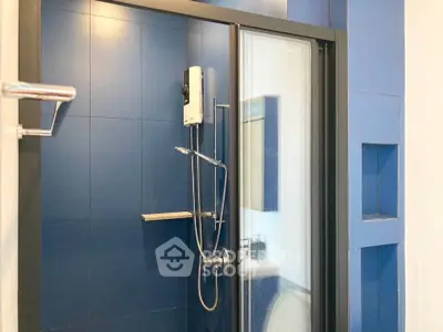 Modern bathroom with sleek blue tiles and glass shower enclosure