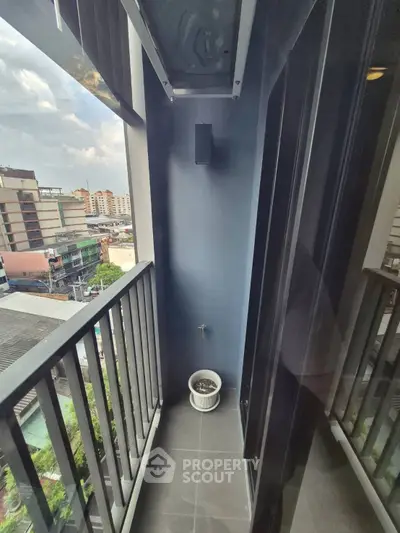 Narrow balcony with city view, perfect for urban living.