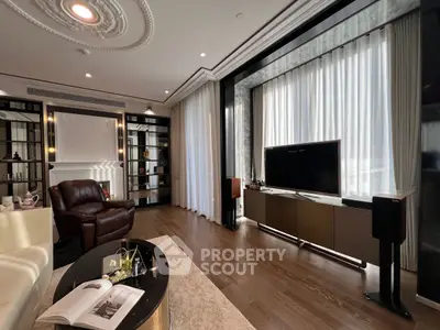 Luxurious living room with elegant decor, large TV, and floor-to-ceiling windows.