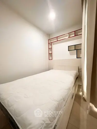 Cozy bedroom with modern shelving and minimalist design, perfect for a restful retreat.