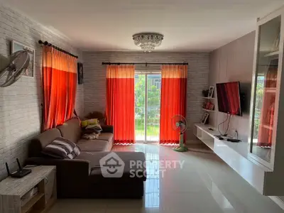 Spacious living room with modern decor and large windows offering natural light.