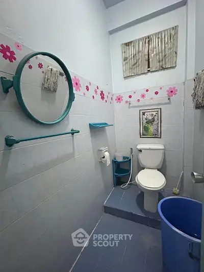 Charming bathroom with floral decor and modern fixtures in cozy home.