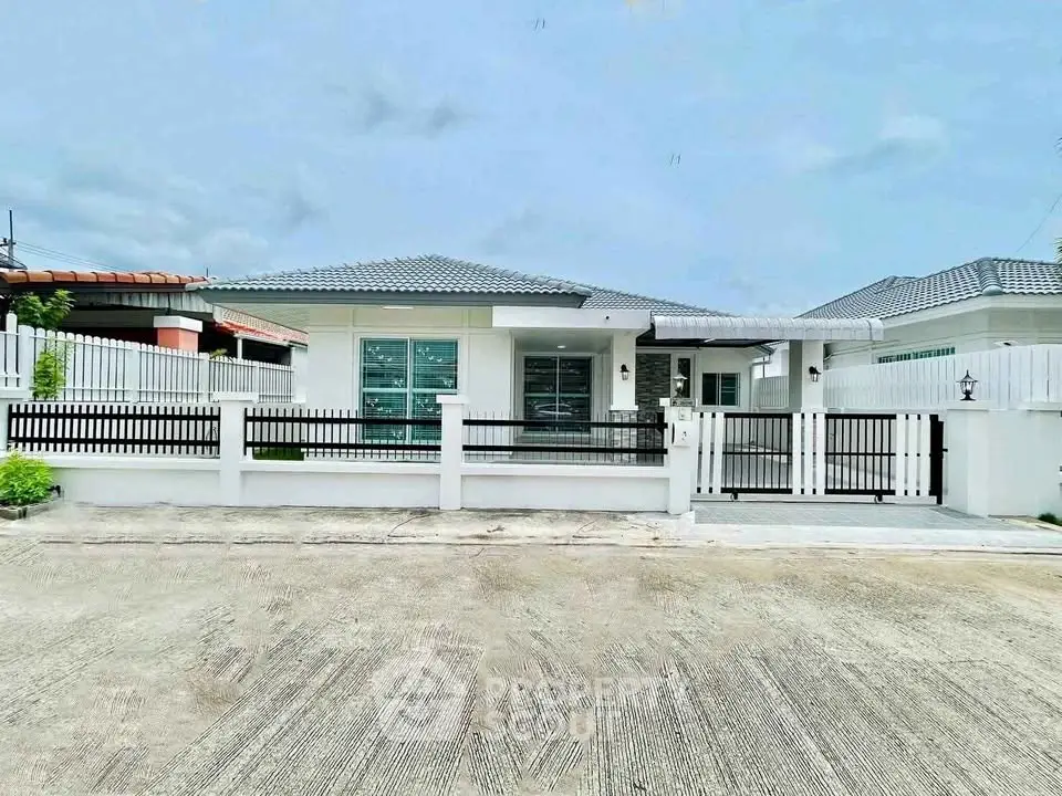 Charming single-story house with modern design and spacious front yard.