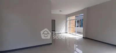 Spacious empty room with large windows and glossy floors, perfect for customization.