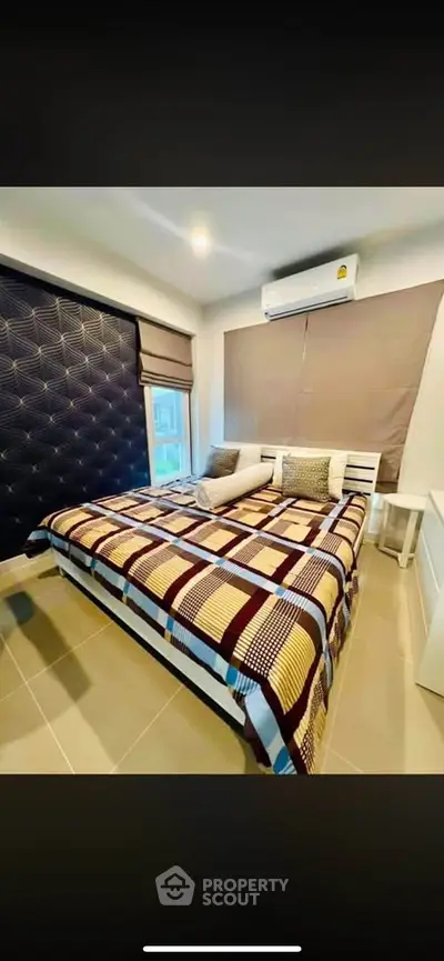 Modern bedroom with stylish decor and air conditioning in a cozy apartment.