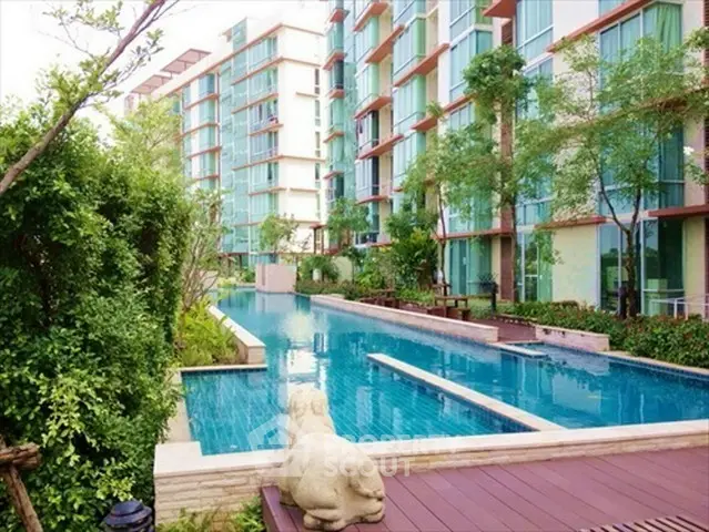 Luxurious apartment complex with stunning pool and lush greenery