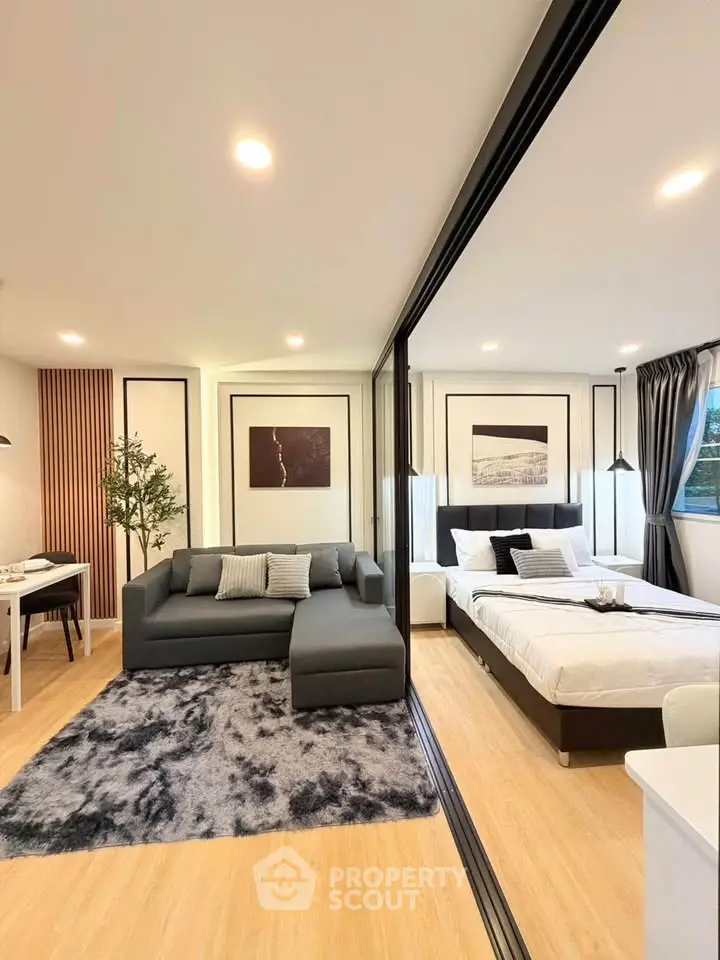 Modern open-plan living room and bedroom with stylish decor and cozy ambiance.