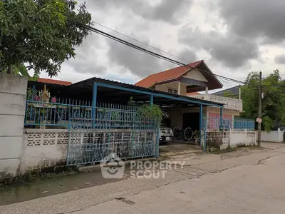Charming suburban house with spacious driveway and lush greenery, perfect for family living.