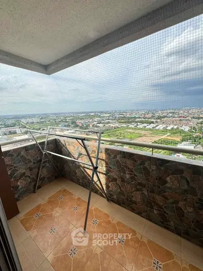 Spacious balcony with panoramic city view and tiled flooring