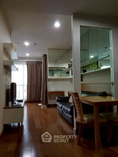 Modern living room with wooden flooring and stylish furniture in a cozy apartment.