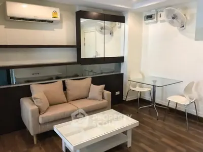 Modern living room with cozy sofa, glass table, and air conditioning in a stylish apartment.