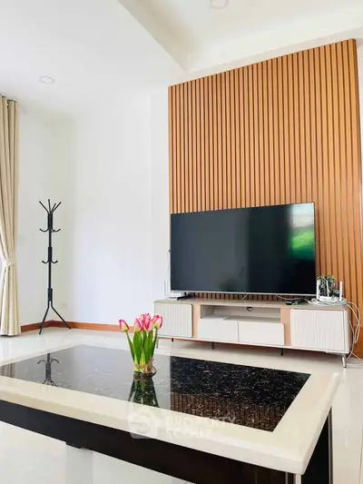 Modern living room with sleek TV setup and elegant decor