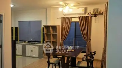 Cozy dining area with modern kitchen in open layout apartment