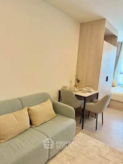 Modern living room with cozy sofa and dining area in stylish apartment