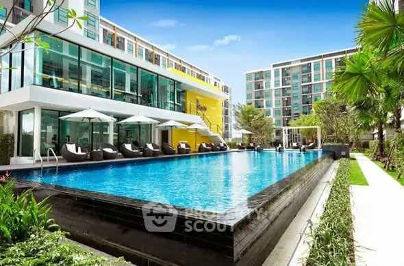 Luxurious modern apartment complex with stunning pool and lush landscaping.