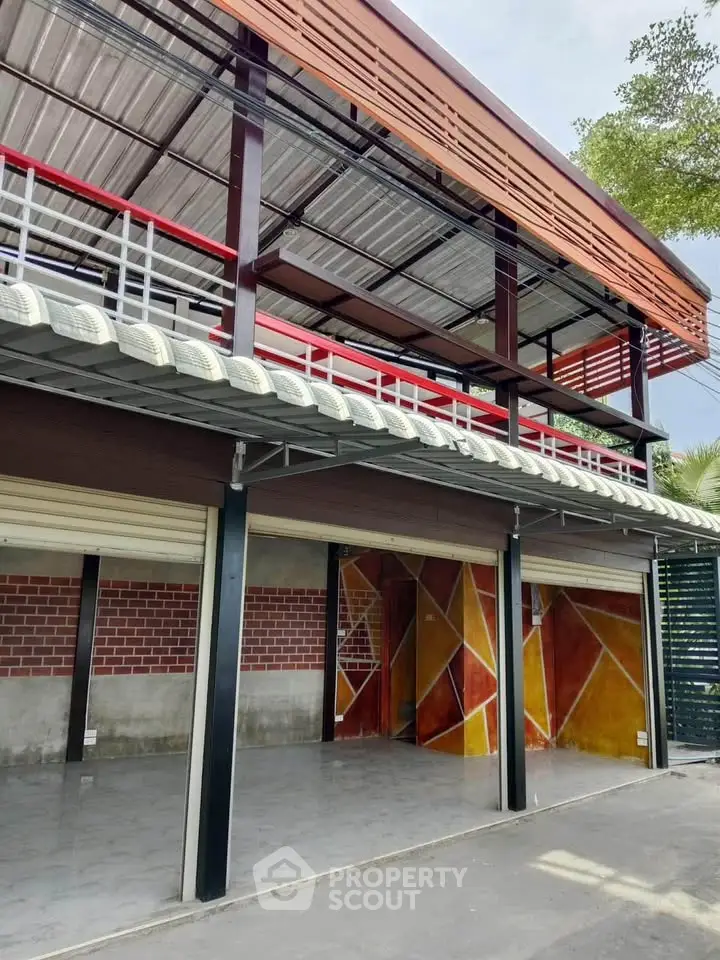 Modern two-story building with unique geometric design and open garage space.