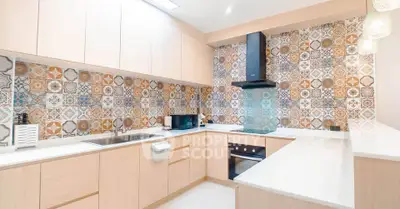 Modern kitchen with stylish patterned backsplash and sleek appliances