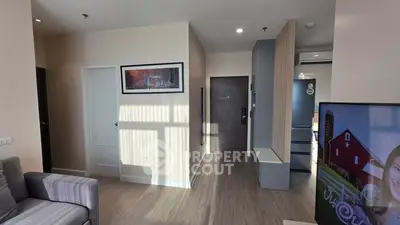 Modern apartment interior with stylish decor and open layout, featuring a cozy living area and sleek kitchen.