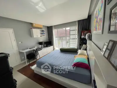 Spacious modern bedroom with large windows, sleek design, and integrated workspace, perfect for professionals seeking comfort and convenience.