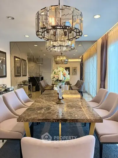 Luxurious dining room with elegant marble table and chic lighting fixtures.