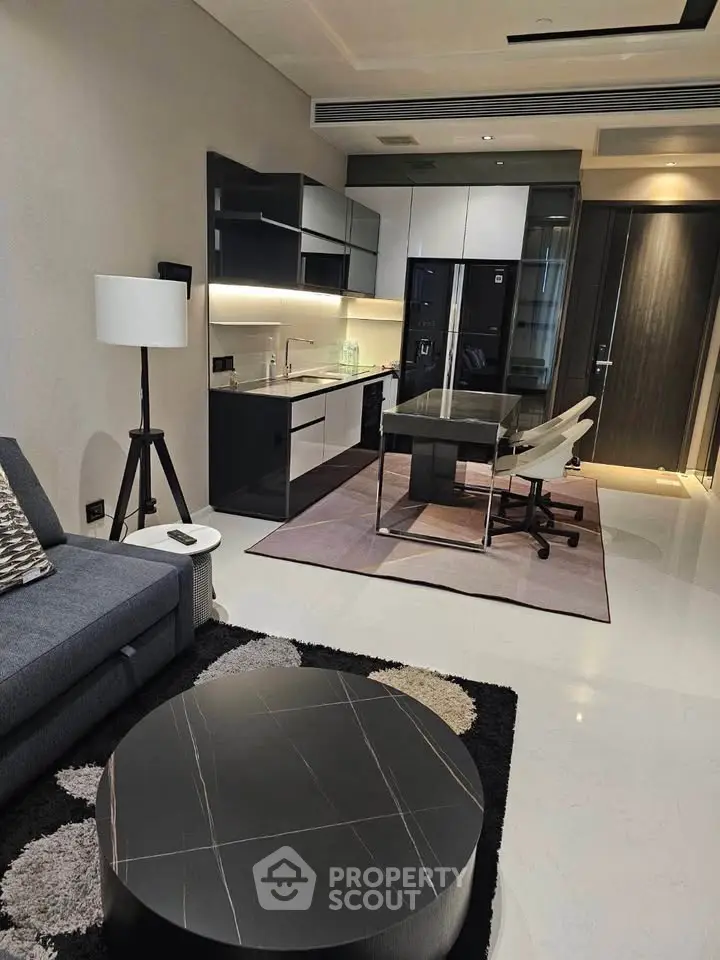 Modern open-layout living room with sleek kitchen and stylish furniture